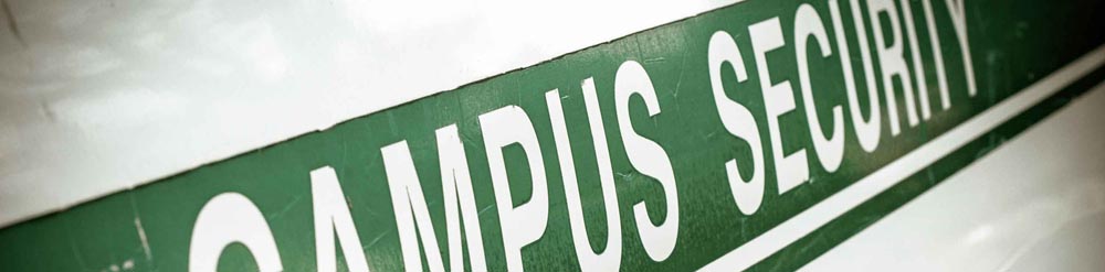 Green campus security sign with white letters